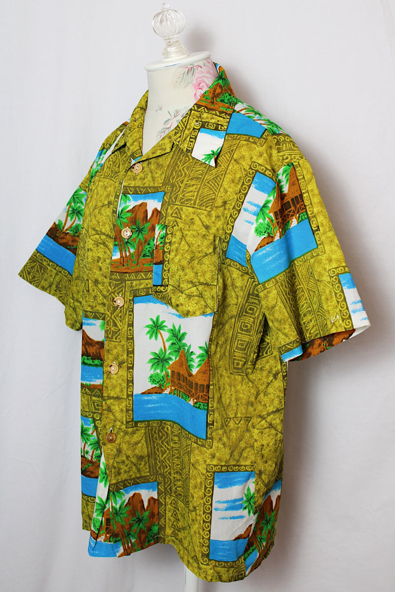 Women's or men's vintage 1970's short sleeve button up shirt in an all over green Hawaiian print.