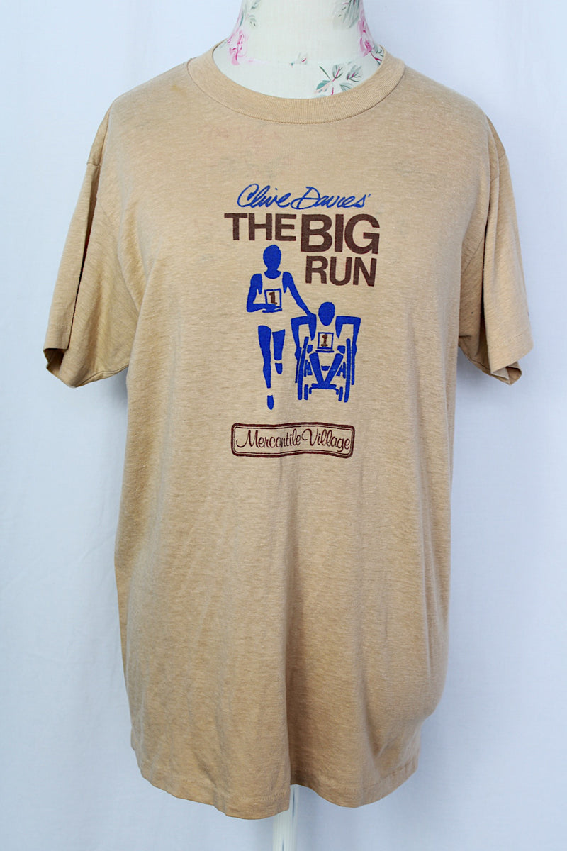Women's or men's vintage 1970's Sport-T label short sleeve tan colored t-shirt with brown and blue graphic on the front.