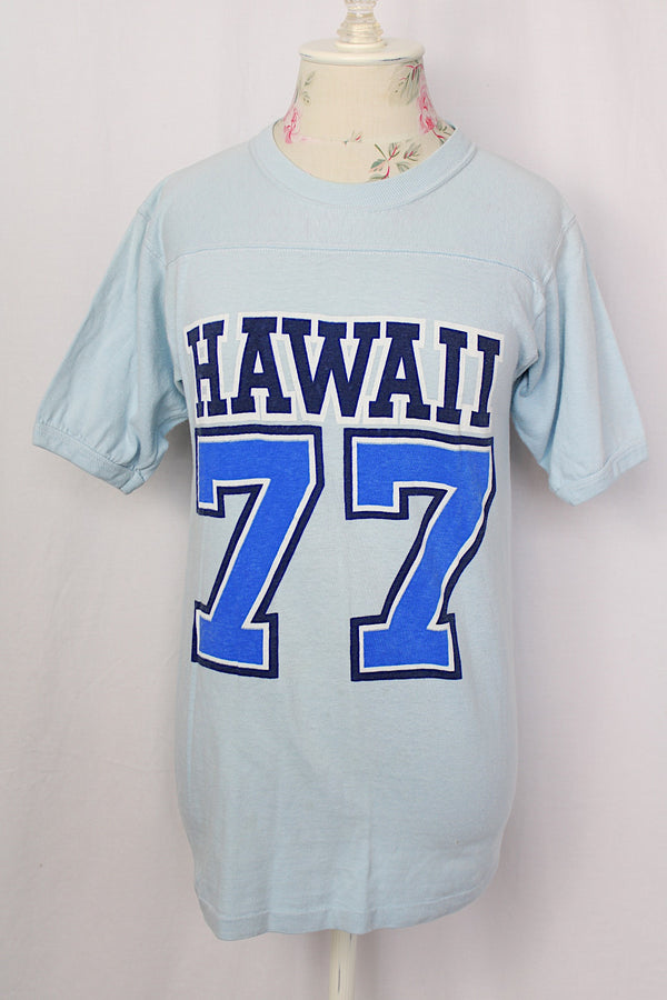Women's or men's vintage 1970's Crazy Shirt Hawaii label short sleeve light blue cotton t-shirt with blue and navy text on front and back.