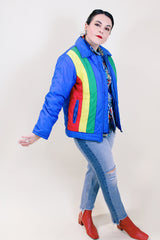 Women's or men's vintage 1970's Montgomery Ward Custom Outerwear label long sleeve ski jacket in blue with yellow, red, and green stripes in the front.