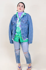 Women's or men's vintage 1990's medium wash blue button up Levi's denim jacket with collar.