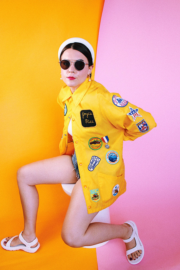 long sleeve yellow nylon windbreaker with patches all over vintage 1960's