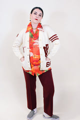 Women's vintage 1960's Kandel All National label long sleeve button up wool cream colored cardigan with two front pockets and various maroon colored patches.