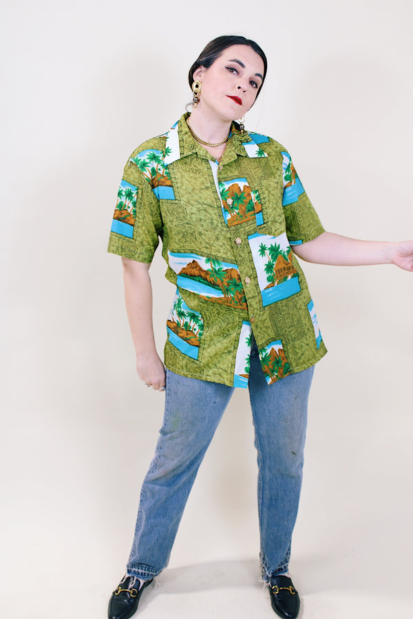 Women's or men's vintage 1970's short sleeve button up shirt in an all over green Hawaiian print.