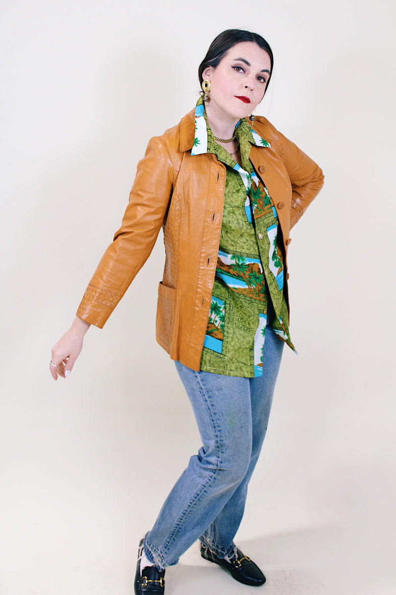 Women's vintage 1970's Suburban Heritage label long sleeve camel colored leather button up jacket.
