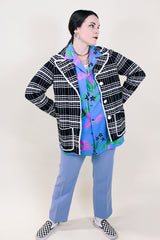 Women's vintage 1960's Lilly of California label long sleeve button up black and white striped cardigan with two front pockets, a double lapel, and white square buttons.