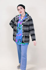 Women's vintage 1960's Lilly of California label long sleeve button up black and white striped cardigan with two front pockets, a double lapel, and white square buttons.