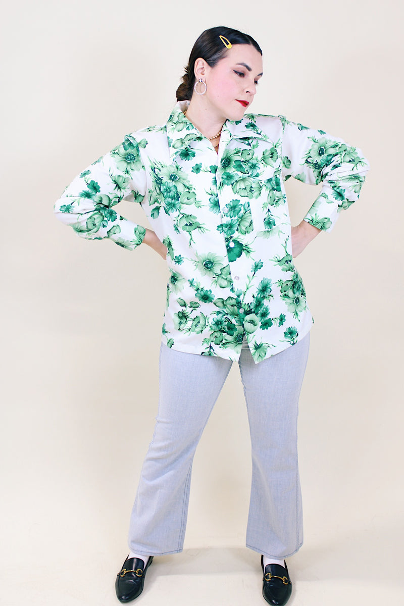 Women's or men's vintage 1970's Triumph of California label long sleeve button up shirt with dagger collar. White polyester with all over green floral print. 