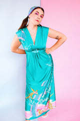 sleeveless maxi length turquoise dress with floral and bird print around hem vintage 1970's