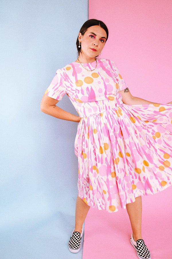 short sleeve midi length 1960's dress in white with pink and orange print