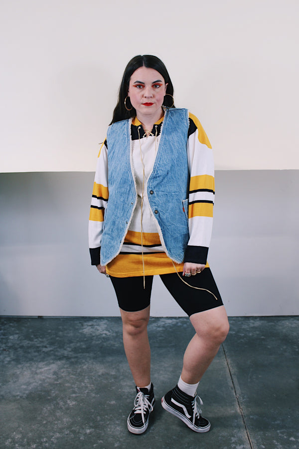 Women's or men's vintage 1970's Levi's label sleeveless light wash denim vest with cream shearling interior. Popper buttons and front pockets. Orange Levi's tab label.