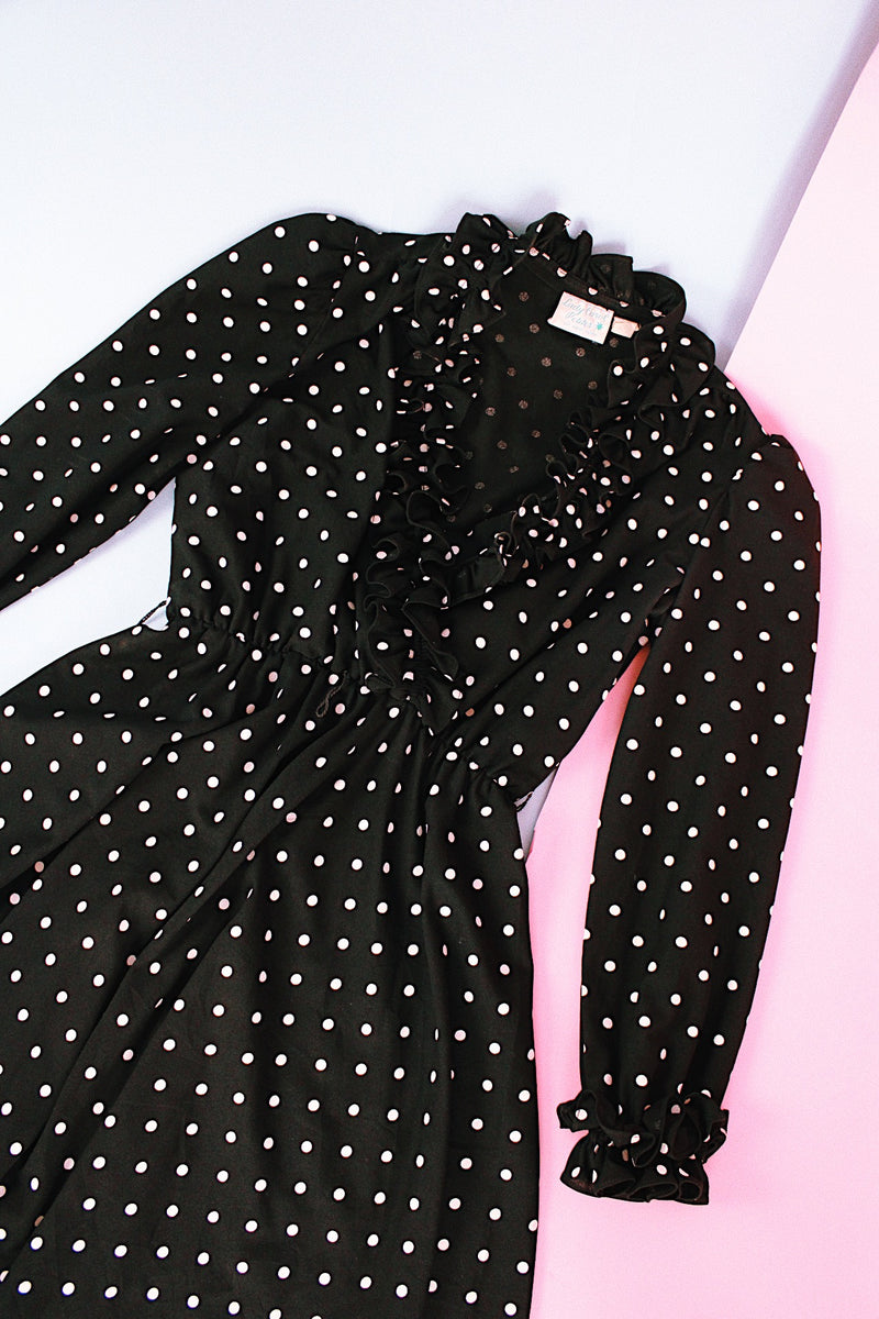 long sleeve knee length black dress with polka dots ruffle neckline and cuffs vintage 1970's