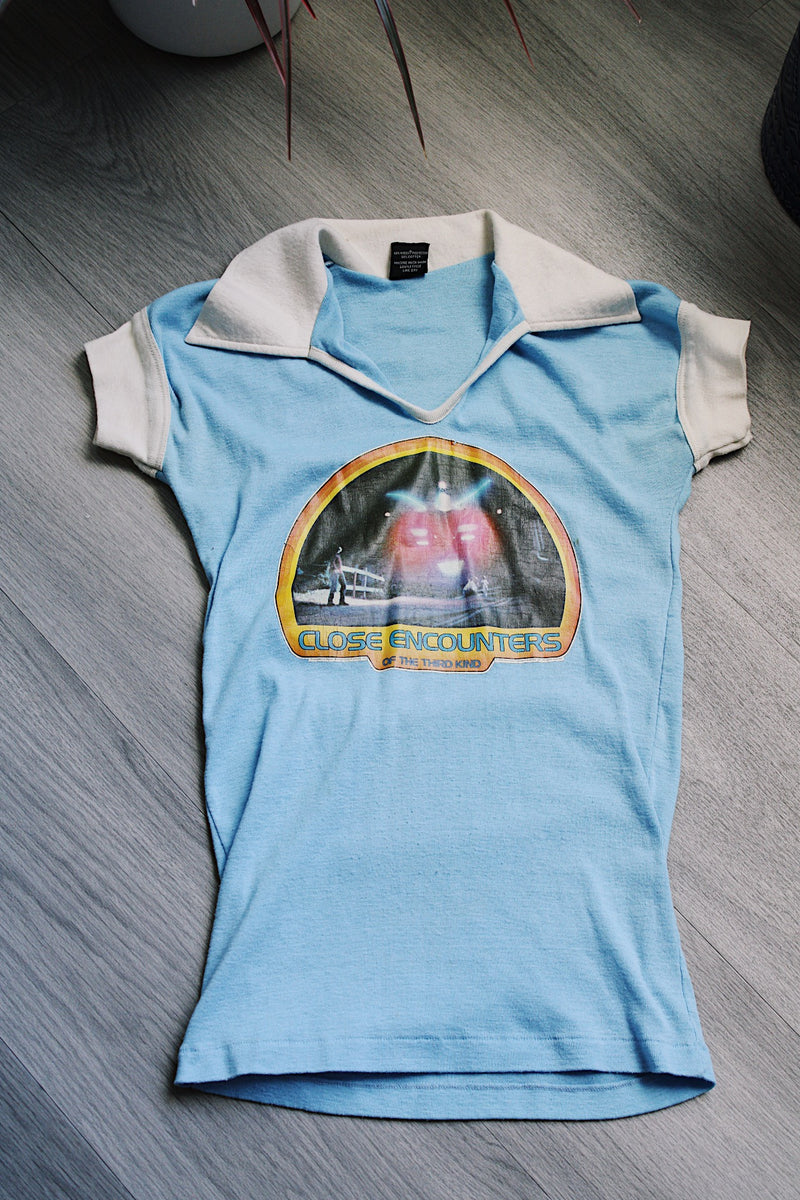 short sleeve baby blue Close Encounters 1978 graphic tee with white trim on cuffs and collar 