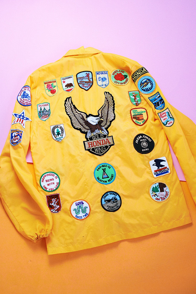 long sleeve yellow nylon windbreaker with patches all over vintage 1960's
