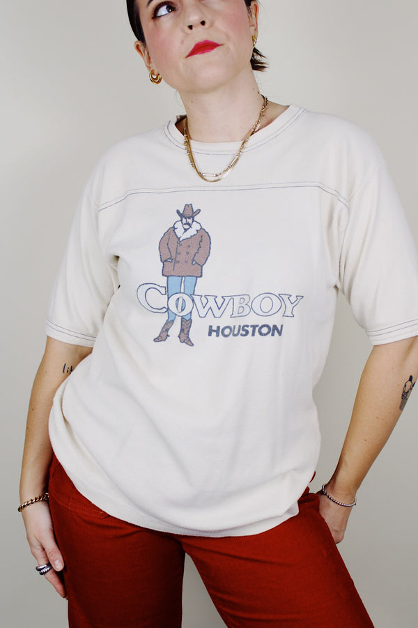 short sleeve cream colored cotton t-shirt with cowboy houston graphic on the front vintage 1970's