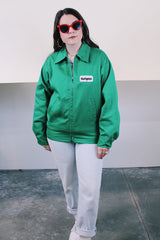 Women's or men's vintage 1970's K-Brand label long sleeve vibrant green zip up station jacket in lightweight cotton with patch on chest.