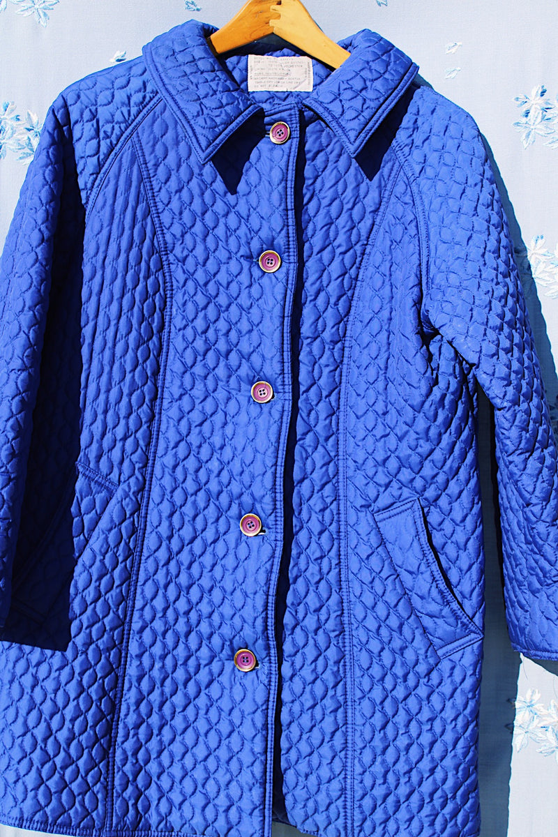 long bright blue quilted puffy coat buttons up the front with collar vintage women's 