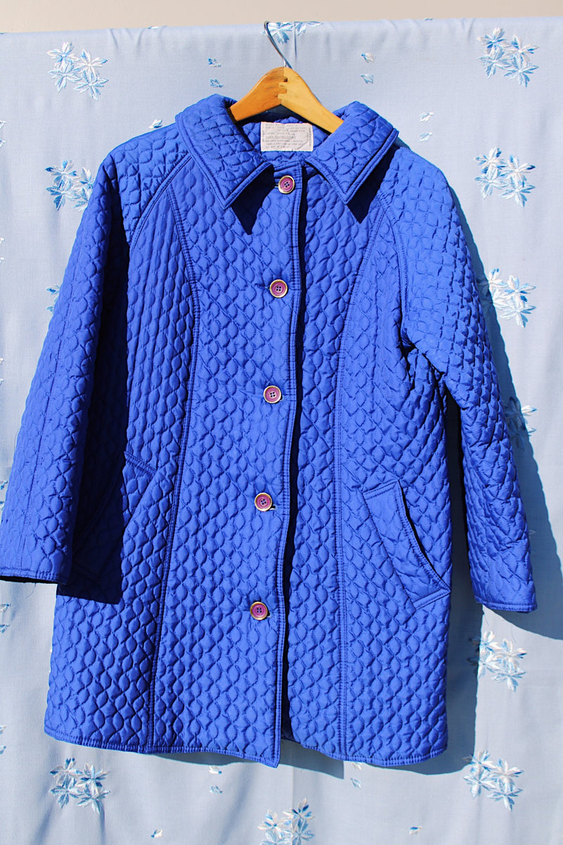 long bright blue quilted puffy coat buttons up the front with collar vintage women's 