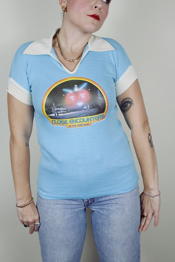 short sleeve baby blue Close Encounters 1978 graphic tee with white trim on cuffs and collar 