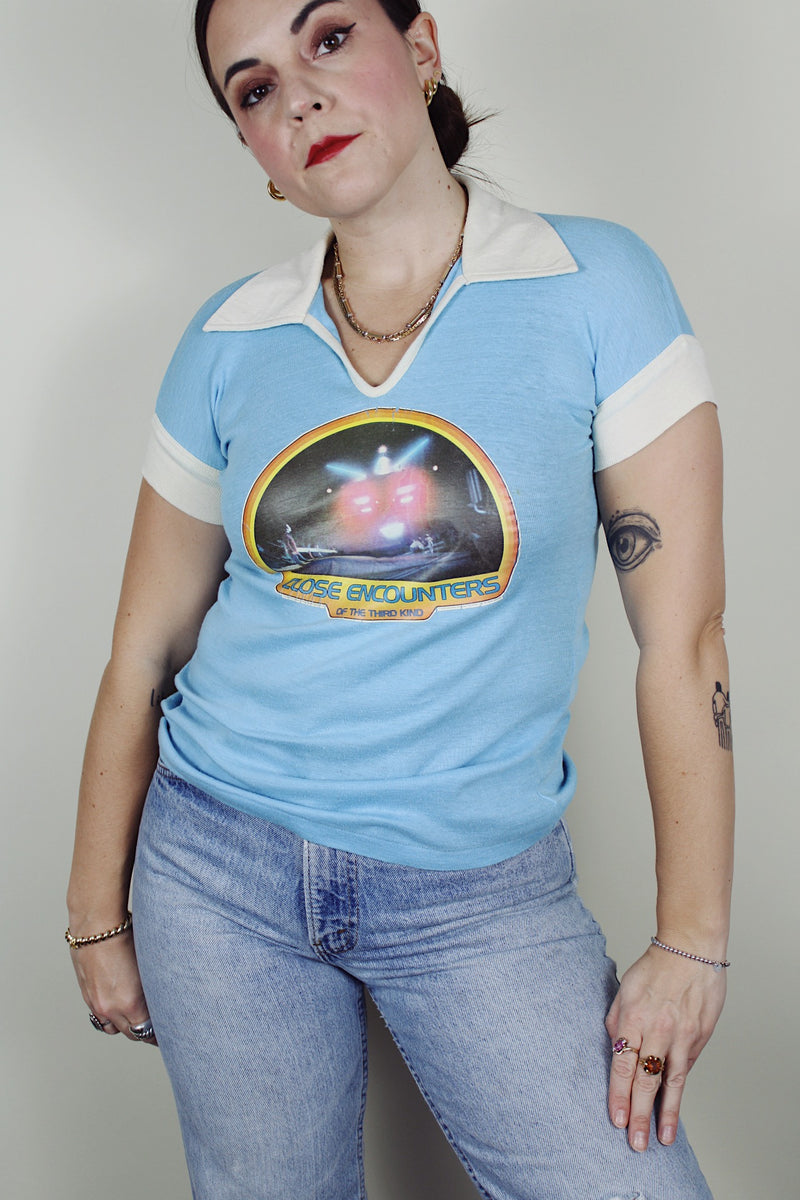 short sleeve baby blue Close Encounters 1978 graphic tee with white trim on cuffs and collar 