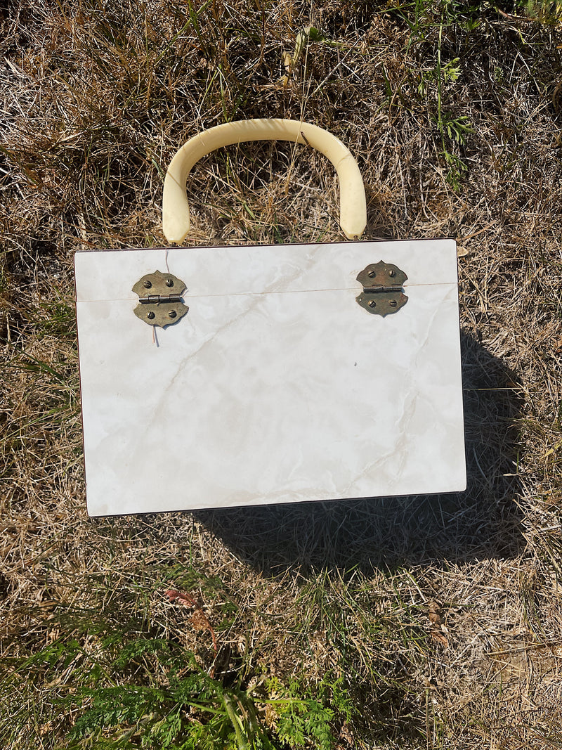 box purse with white marble panels and one side with painting plastic handle and green velvet interior vintage 1960's