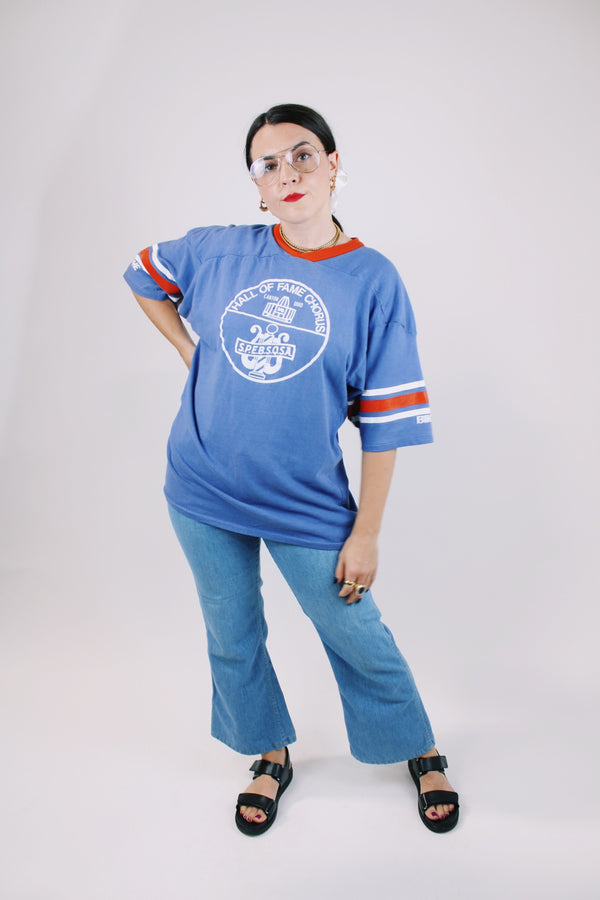 short sleeve blue t-shirt with red and white stripes on arm graphic on front and back vintage 1970's