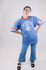 short sleeve blue t-shirt with red and white stripes on arm graphic on front and back vintage 1970's