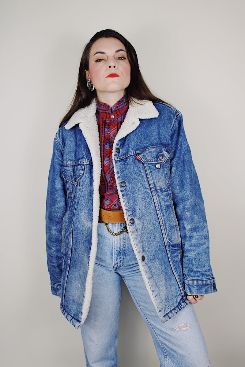 vintage 1970's Levi's San Francisco long sleeve medium wash denim jacket with a white shearling liner and a long fit