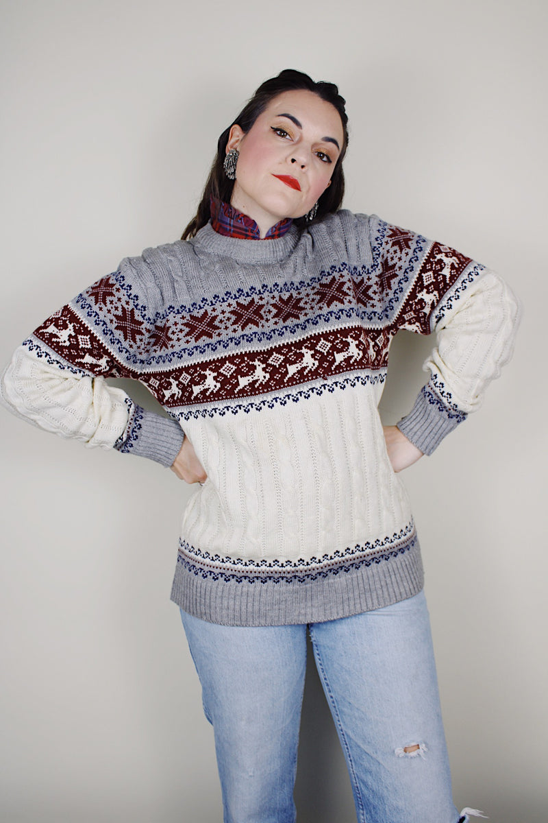 vintage 1980's High Sierra Mervyn's long sleeve cable knit pullover print with a reindeer print across the chest. White with grey, maroon, and navy print.