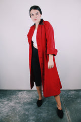 1950's red quilted duster coat with black velvet trim has pointy collar and buttons up the front
