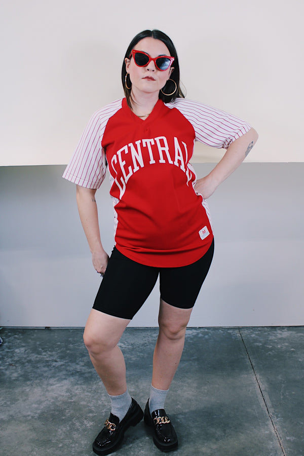 Women's or men's vintage 1970's Champion Products Inc. label short sleeve red and white colored Nylon material sports jersey with V shaped neckline and text on front and back.