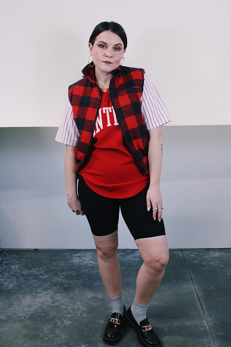 Women's or men's vintage 1980's Ozark Trail label sleeveless zip up black and red buffalo plaid vest with side pockets in cotton material.