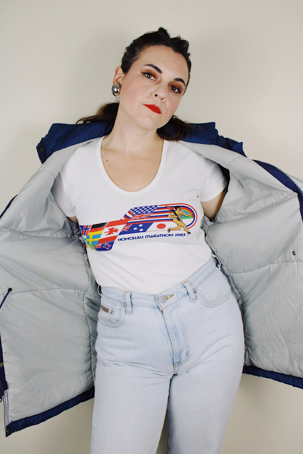 vintage 1980's Woolrich, Made in USA label long sleeve dark blue zip up parka jacket with removable hood, four front velcro pockets, and brass popper buttons