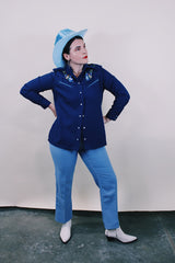 Women's vintage western style 1970's California Ranchwear label long sleeve navy blue blouse with pointy collar and pearly blue popper buttons. Has floral embroidery on shoulders.