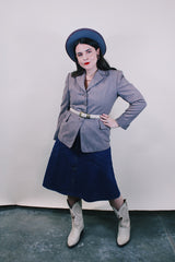 Women's vintage 1950's Jack Frost Woolen Wear, The Original Utah Woolen Mills, Salt Lake City label long sleeve grey colored button up blazer with double lapel, two pockets, and fabric covered buttons.