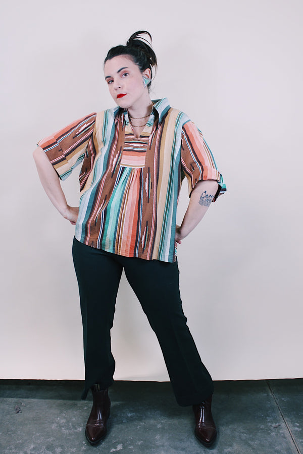 Women's vintage western style 1980's short sleeve pullover blouse in green, peach, and brown vertical striped patterns. Collar and V shaped neckline.