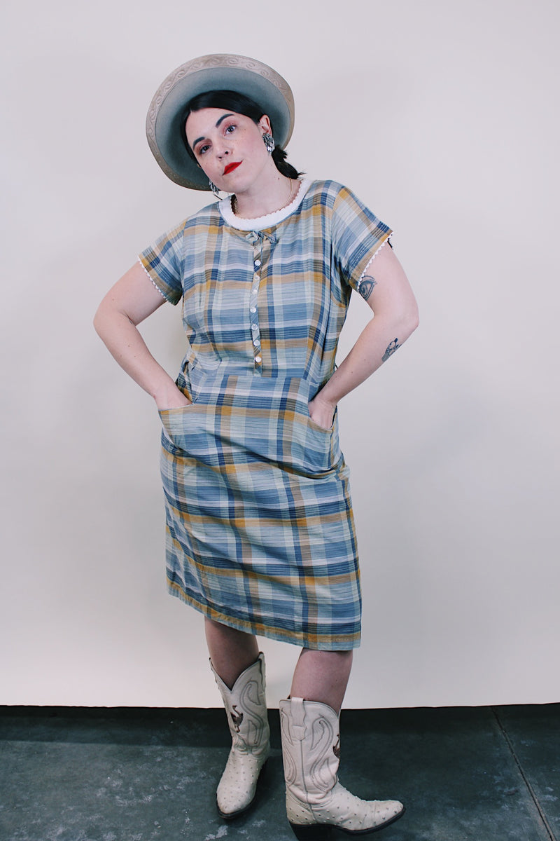 Women's vintage western style 1960's short sleeve midi length plaid print shift dress with white scalloped trim. Grey, teal, and mustard yellow colors.