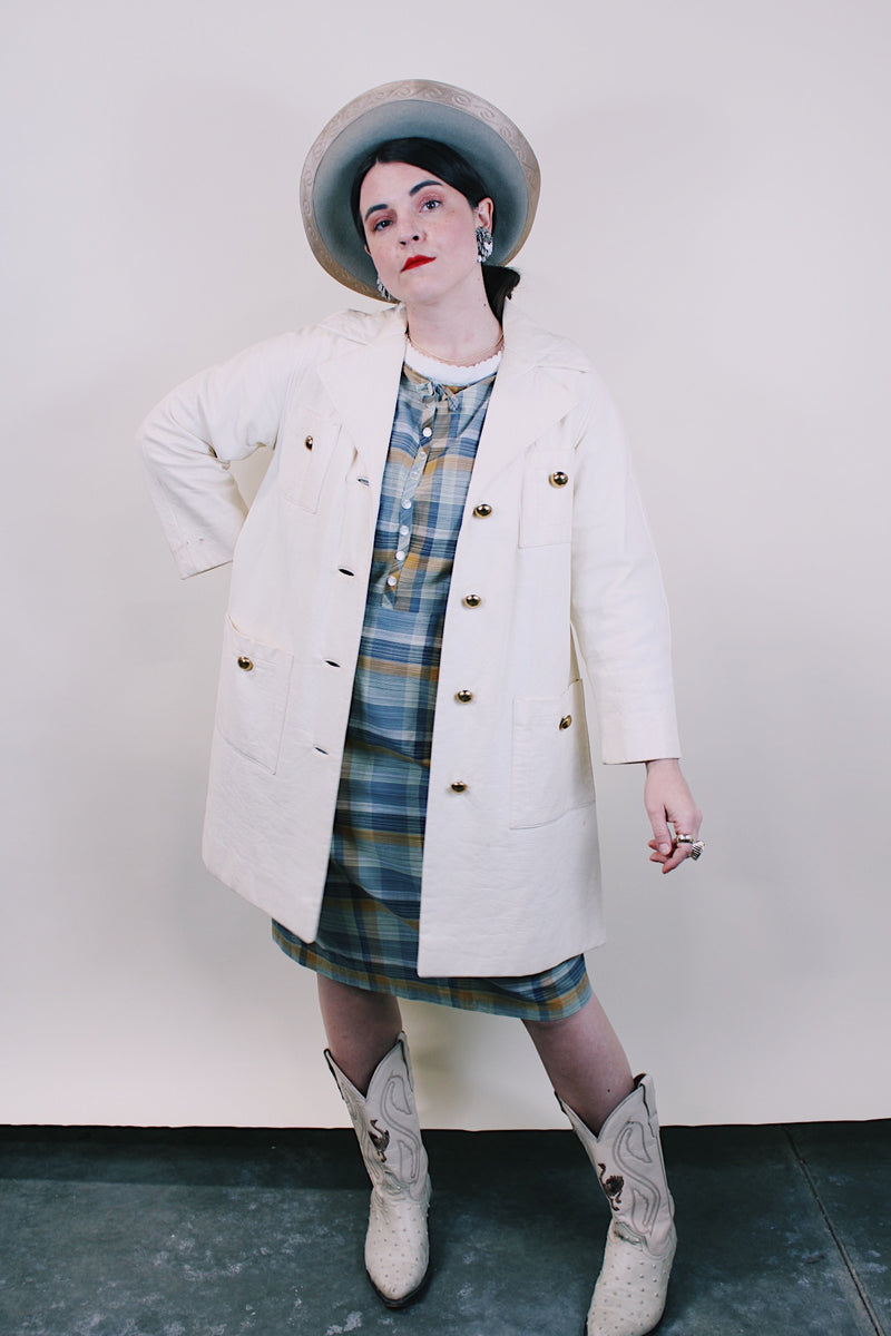 Women's vintage 1960's Lilli Ann, Paris & San Francisco label 3/4 arm length long length cream colored vinyl polyester coat with big round gold buttons and four front pockets