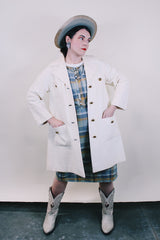 Women's vintage 1960's Lilli Ann, Paris & San Francisco label 3/4 arm length long length cream colored vinyl polyester coat with big round gold buttons and four front pockets