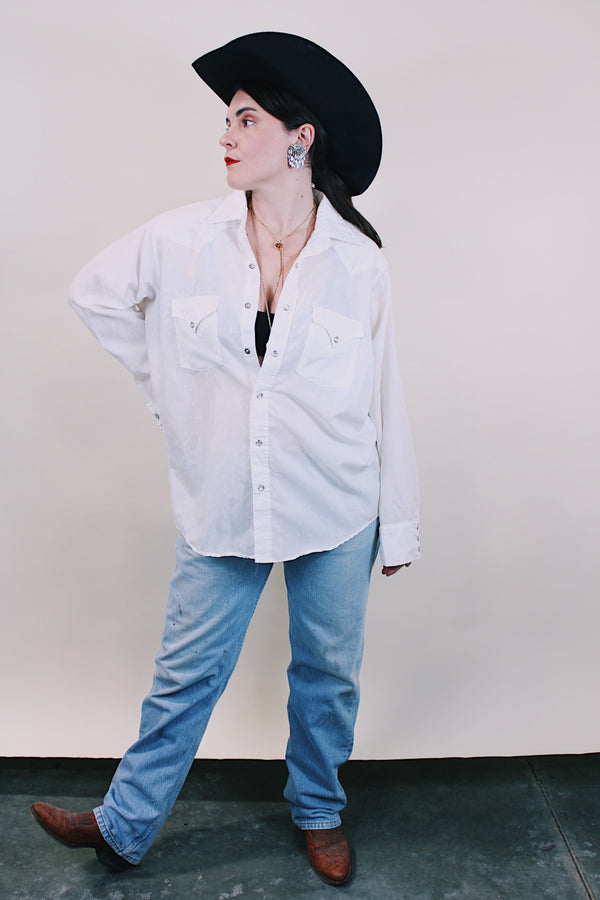 Women's or men's western style vintage 1970's Ely Plains, Since 1978 label long sleeve white button up shirt with pockets, collar, and pearl snapper buttons.