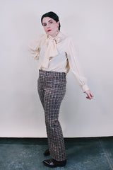 Women's or men's vintage western style 1970's polyester material brown plaid pants in chocolate brown, tan, and white. Four pockets, belt loops, and zipper closure with slight bell bottoms. 