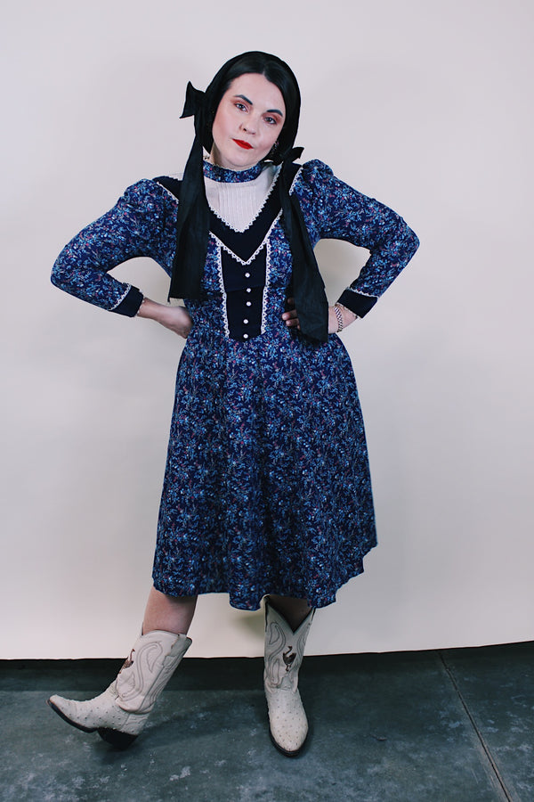 Women's vintage western style 1970's Candi Jones California label long sleeve midi length prairie dress in navy cotton material with all over ditsy floral print.