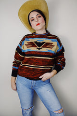 vintage 1970's Montgomery Ward long sleeve acrylic material pullover sweater with a brown, maroon, tan, and blue all over print