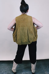 Men's vintage 1950's Bullseye Bill label sleeveless brownish green hunting vest with brass rapid zipper, multiple pockets and compartments and wide arm holes.