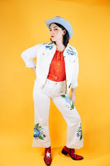 white jacket and pant set with floral embroidery throughout vintage women's 1970's
