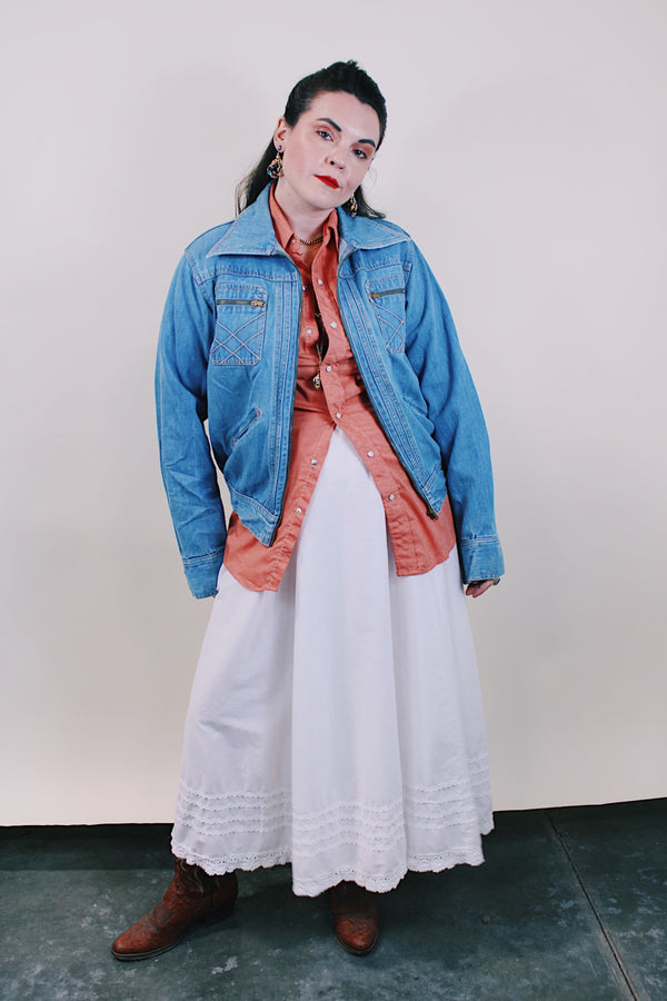 Women's or men's vintage western style 1970's Britannia Sportswear label long sleeve medium wash denim zip up jacket with chest pockets, side pockets, and contrast stitching