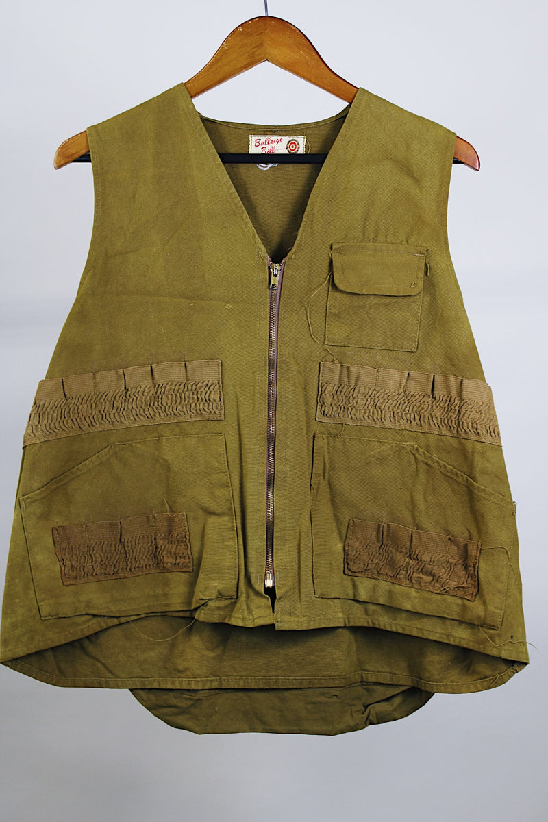 Men's vintage 1950's Bullseye Bill label sleeveless brownish green hunting vest with brass rapid zipper, multiple pockets and compartments and wide arm holes.