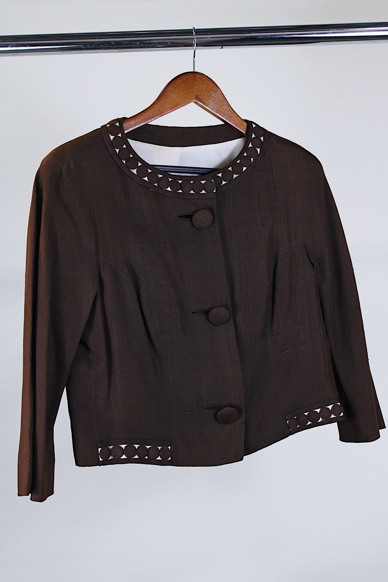 Women's vintage 1960's Buddy Bates label pure silk 3/4 arm length cropped chocolate brown jacket with round neck, three fabric covered buttons, and a full liner. 