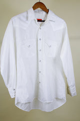 Women's or men's western style vintage 1970's Ely Plains, Since 1978 label long sleeve white button up shirt with pockets, collar, and pearl snapper buttons.