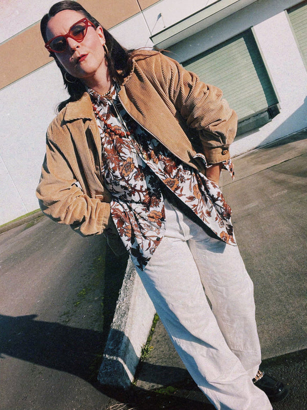 Men's vintage 1970's long sleeve button up shirt with a pointy collar in a lightweight Polyester material. White with all over brown floral print.